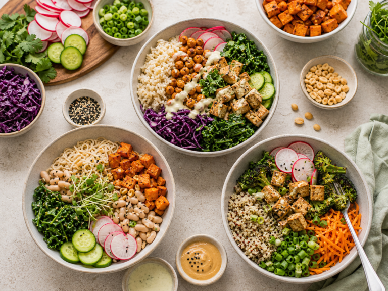 Three colorful vegan weeknight bowls with tofu, chickpeas, greens, noodles, grains, radishes, cucumber, herbs, seeds, and sauces.
