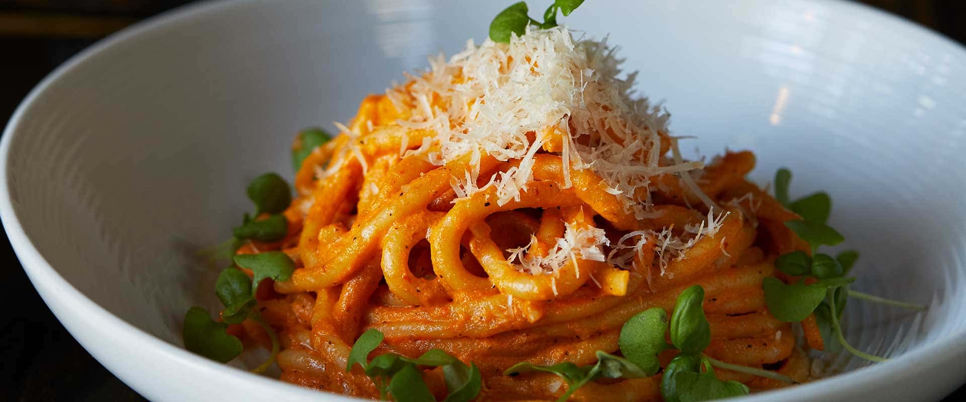 A Pura Vita pasta dish in a white bowl.