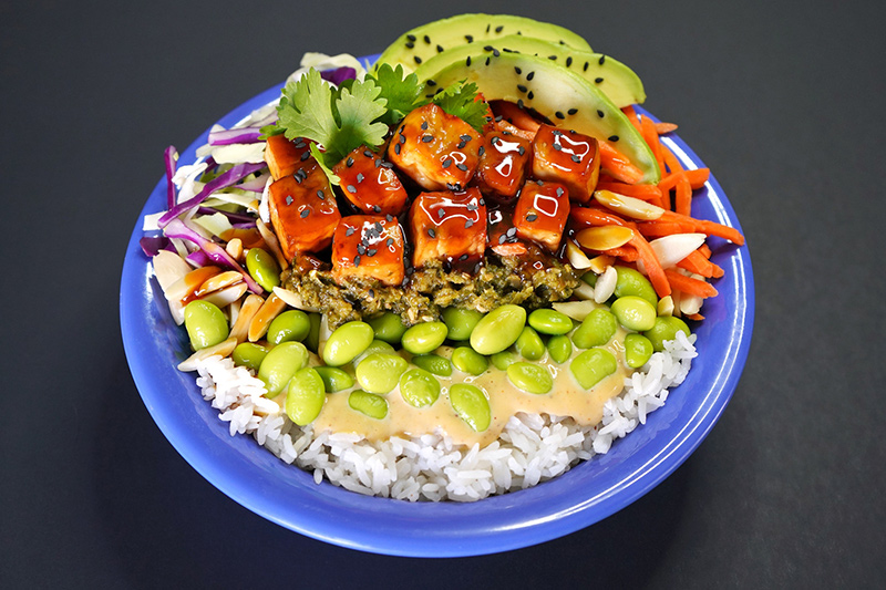 Cafe Yumm bowl with rice, vegetables, edamame, avocado, and sauce at PDX.