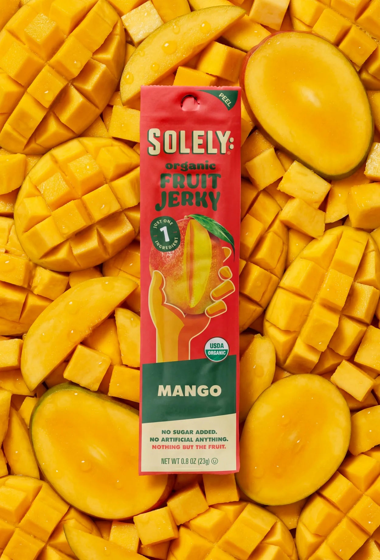 Solely Organic Mango Fruit Jerky pouch on a background of sliced mango.