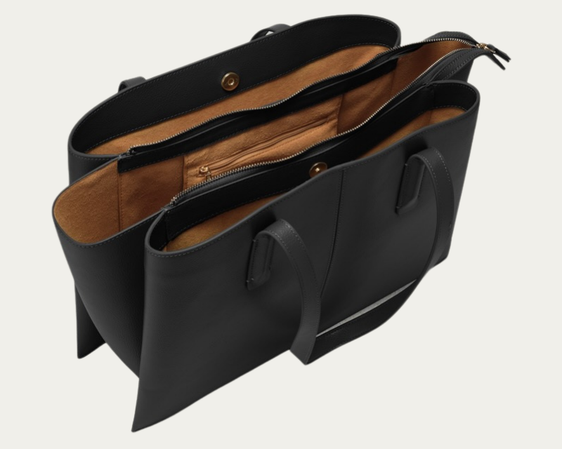 Black Freja Paloma Tote opened to show its zipped center compartment, two open sections, magnetic snaps, and warm brown lining.