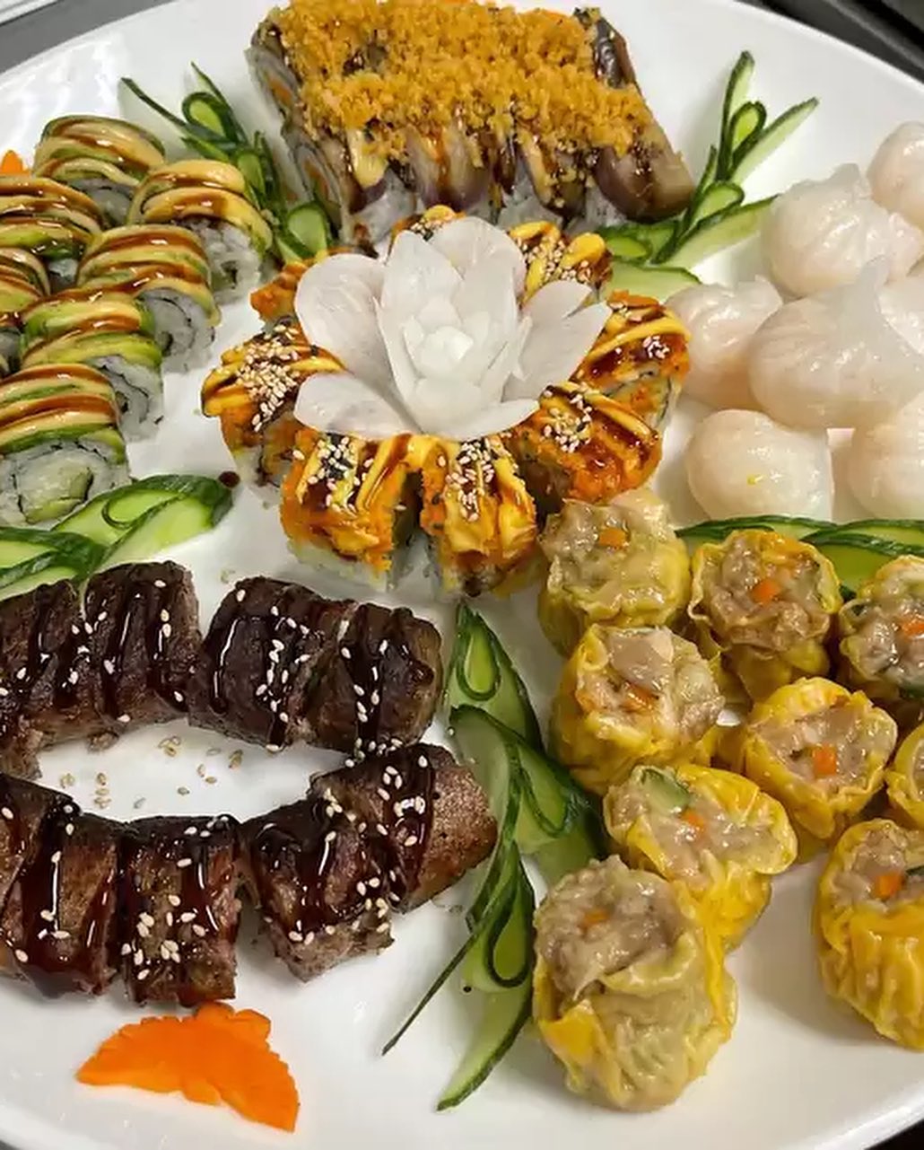 Chef Kenny Vegan Dim Sum platter with yellow siu mai, translucent dumplings, and sushi rolls.
