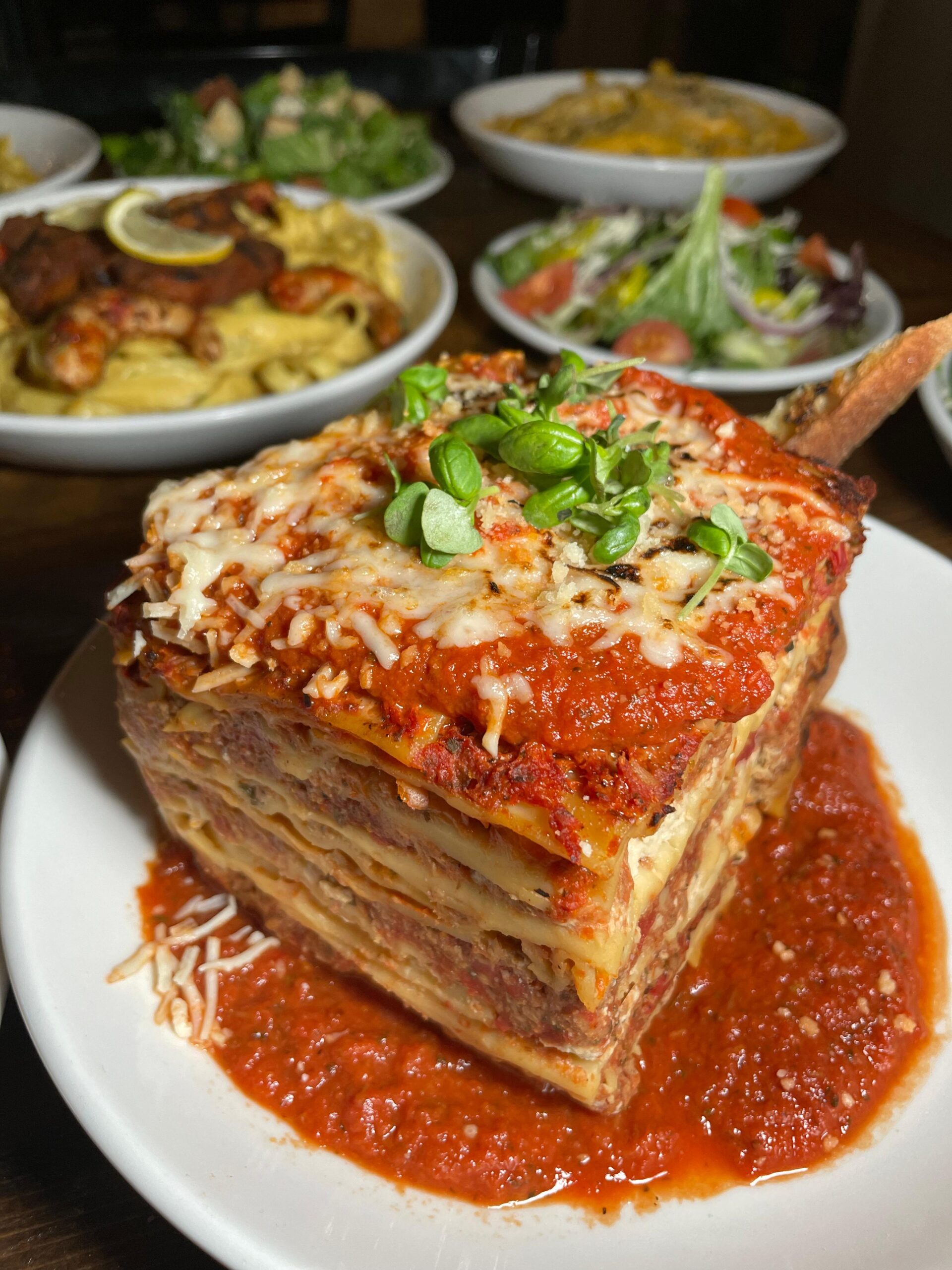 A slice of lasagna covered in tomato sauce and basil at Tarantino's Vegan, one of Las Vegas's vegan restaurants.