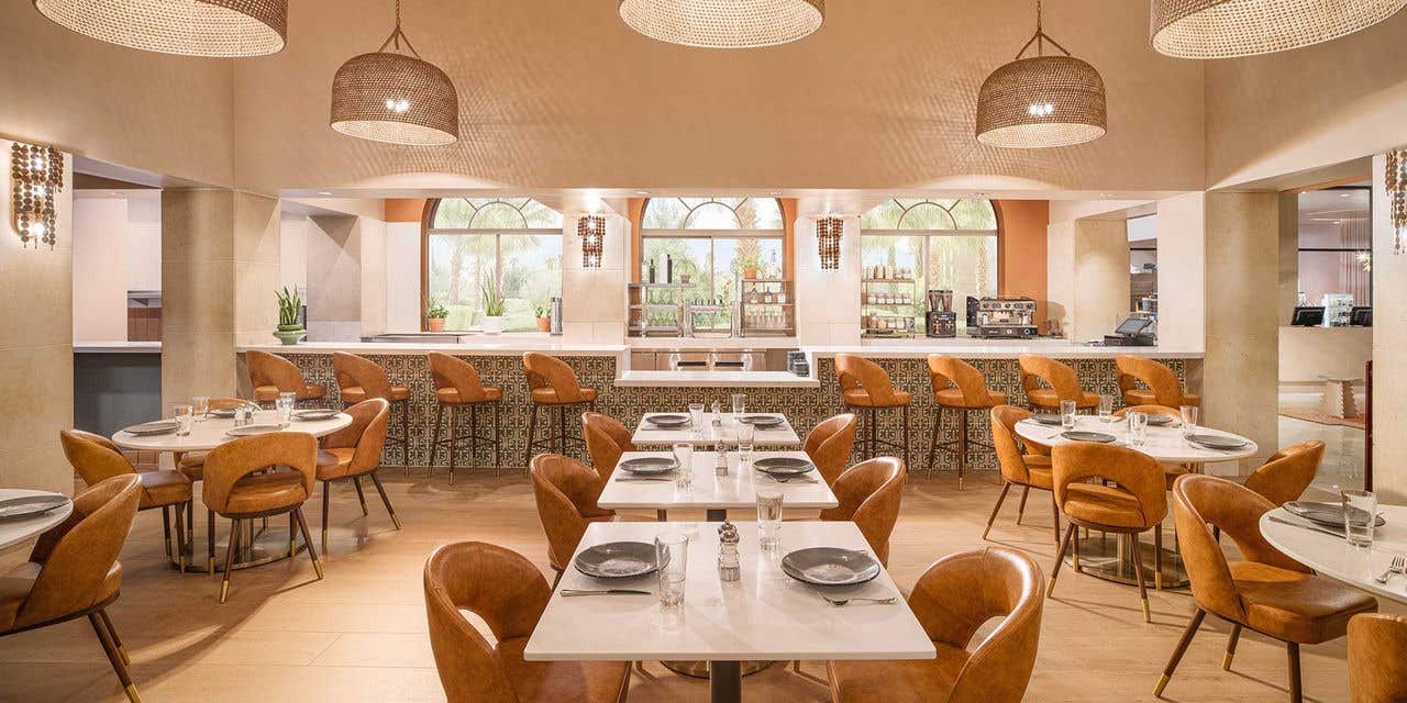Truth & Tonic café at The Venetian, with dining tables, light wood chairs, and a counter.