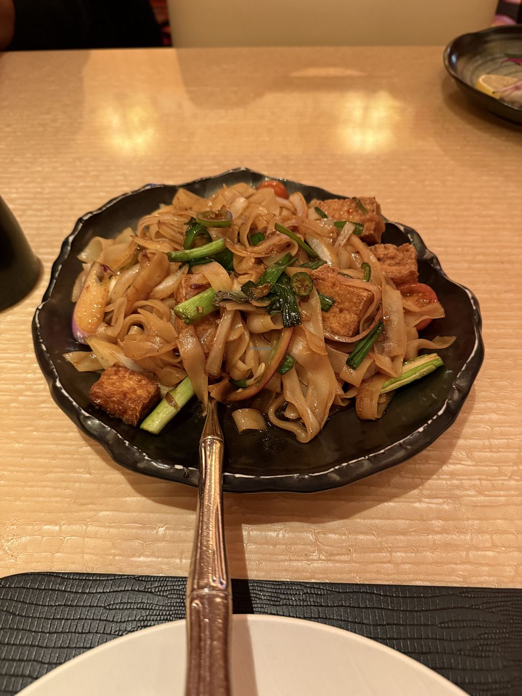 Wazuzu vegan drunken noodles with tofu in a black bowl at Encore Las Vegas.